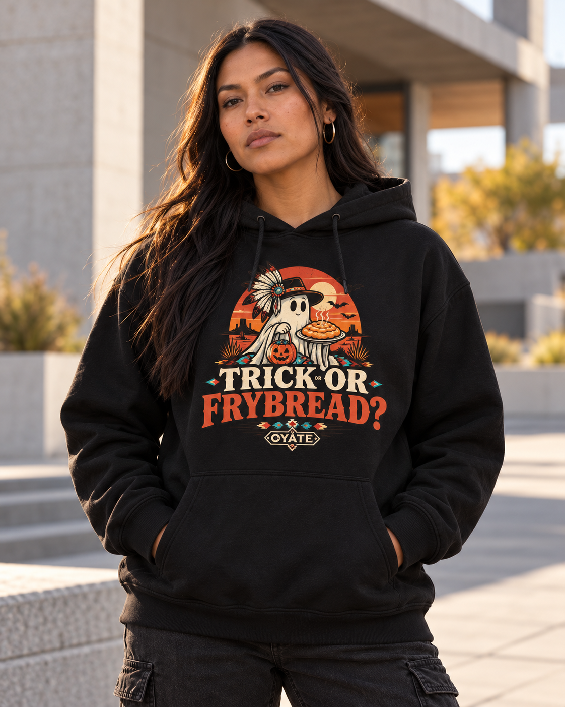 Model wearing OYÁTE Trick or Frybread black hoodie outdoors